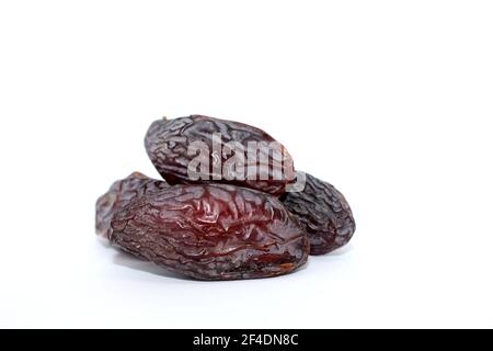 Fresh dried dates Medjool, close-up isolated on white background. Iftar food Stock Photo