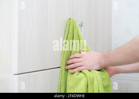 a person drying hands with towel in bathroom, washing dirty hands Stock Photo