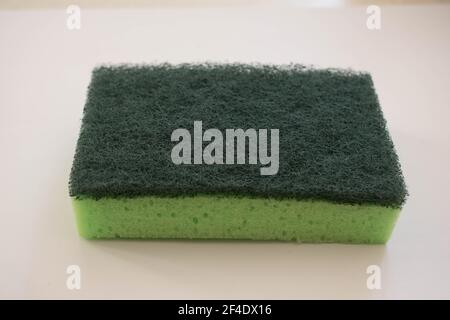Polyurethane cleaning green sponge isolated on white background.Sponge for washing dishes Stock Photo
