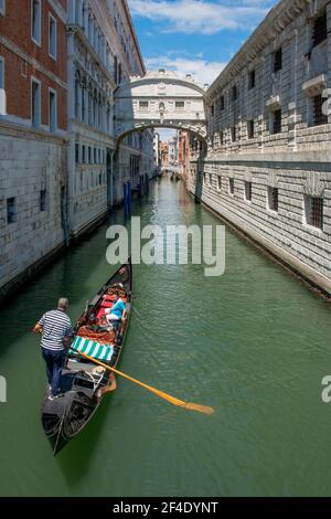 venice italy july 18 2020: Gondola with tourists at the bridge of sighs in venice