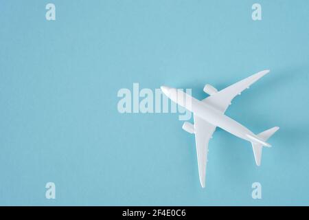 White airplane on blue background, top view Stock Photo