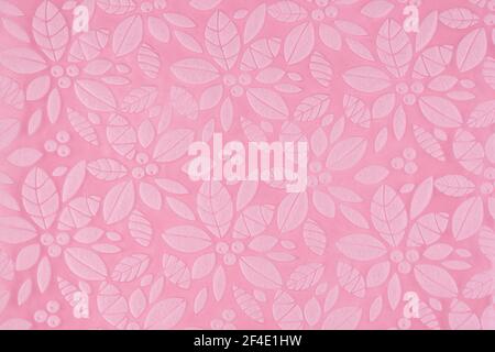 Pink background with embossed leaves and flowers, minimalist space for text Stock Photo