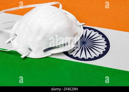 India flag and N95 face mask. Concept of Covid-19 coronavirus lockdown, travel ban and healthcare crisis Stock Photo
