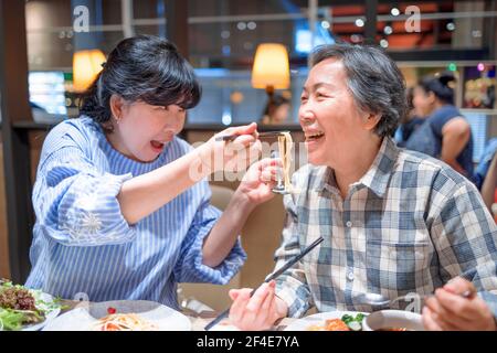 Happy mother and daughter having fun in  restaurant Stock Photo
