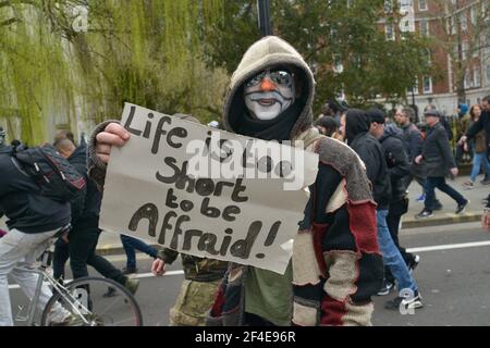 A protester marching with a placard expressing his opinion during the demonstration. Thousands of people had illegally gathered for anti-lockdown demonstration in London, breaking national lockdown rules. Stock Photo