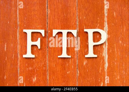 Alphabet letter in word FTP (Abbreviation of File Transfer Protocol) on old red color wood plate background Stock Photo
