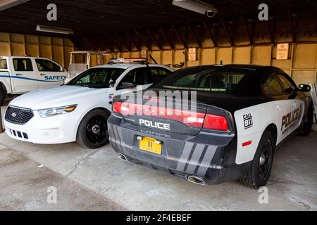 Police vehicles sit under a carport at Purdue University Fort Wayne. Stock Photo