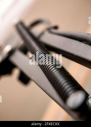 Black spring on metal construction - selective focus Stock Photo