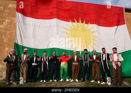 Iraqi Kurds dancing next to the Kurdistan flag during the Nowruz ...