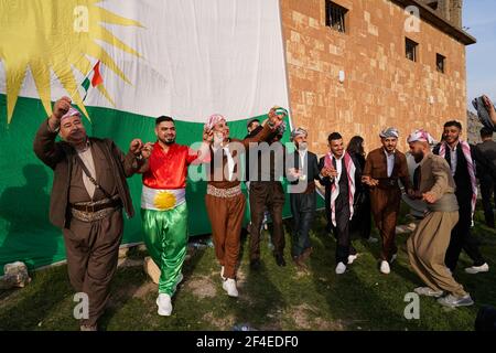 Iraqi Kurds dancing next to the Kurdistan flag during the Nowruz ...