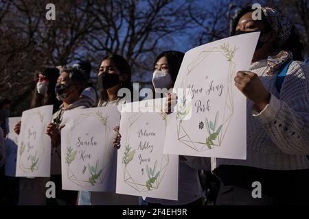 New York City, USA. 20th Mar, 2021. People hold signs with the names of the victims of eight people killed in recent shootings at three spas in Atlanta, Georgia during a vigil in Washington Square Park in New York City, USA. Credit: Chase Sutton/Alamy Live News Stock Photo