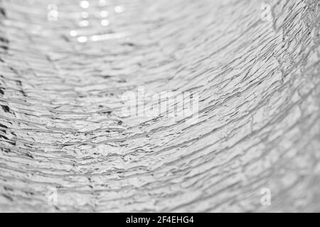 Crumpled aluminum foil texture. Shallow depth of field Stock Photo