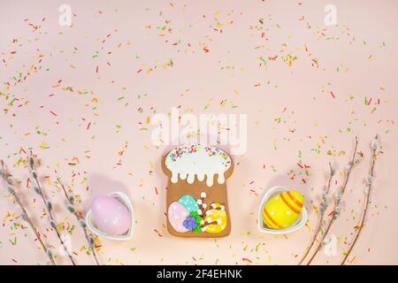 Gingerbread in the form of a easter cake, colorful eggs and tree branches on festive background. Easter Holiday, Stock Photo