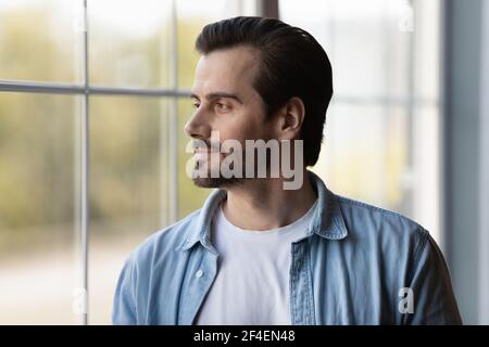 Pensive young man look in distance thinking Stock Photo