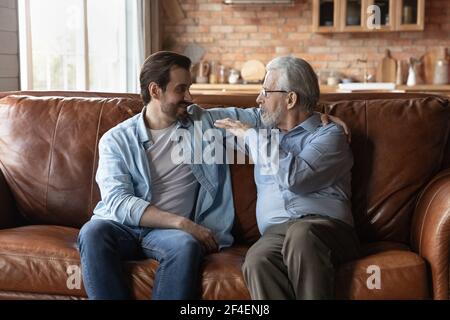 Mature father enjoy weekend talking with grownup son Stock Photo