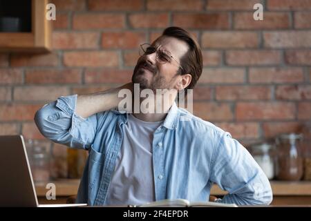 Unwell man suffer from backache working on computer Stock Photo