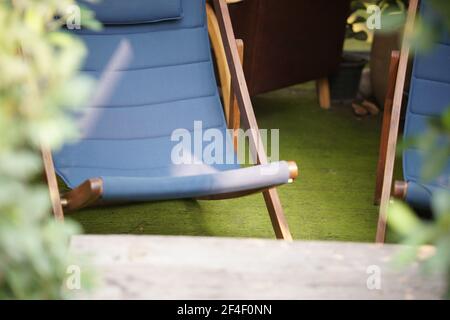 blue fabric collapsible chaise lounge for resting. deck chair deckchair Stock Photo