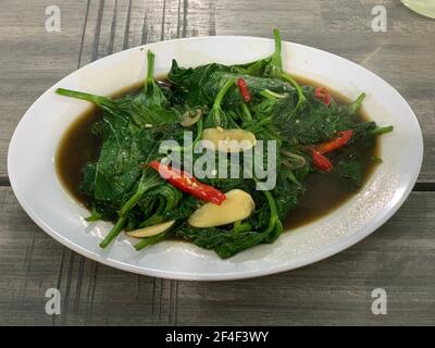 Closeup of cah kangkung, kangkong, or water spinach stirred. Stock Photo