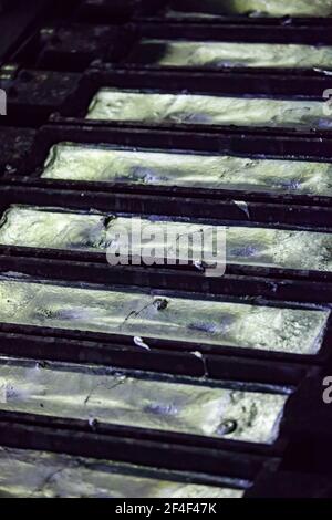 Pavlodar Aluminium electrolysis plant. Foundry aluminium ingots on machine. Close-up photo Stock Photo