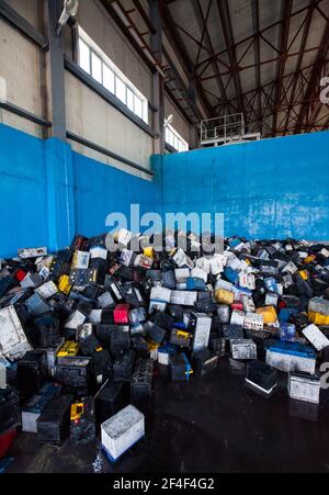 Taldykorgan, Kazakhstan - June 06 2012: Accumulator recycling plant Kainar. Used plastic boxes of batteries on warehouse ready for processing. Stock Photo