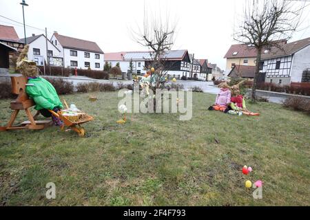 Brausndorf, Germany. 21st Mar, 2021. Easter bunnies made of straw and colourfully painted Easter eggs on a bush can be seen in the village square. Credit: Bodo Schackow/dpa-Zentralbild/dpa/Ģ����ý Live News Stock Photo