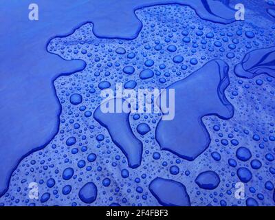 Droplets of rainwater on the blue tarp Stock Photo