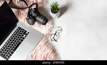 flat lay of workspace with laptop eyeglasses photo camera on white background Stock Photo