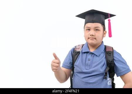 Smart asian student wear graduation cap and showing thumb up and looking at camera isolated on white Stock Photo
