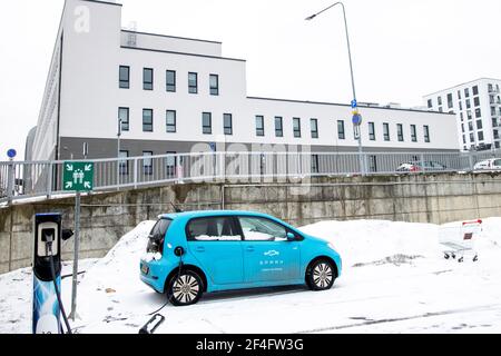 Electric car Volkswagen up at the Spark charging point. Green energy and zero emission theme. Sustainability and future of the nature and clean world. Stock Photo
