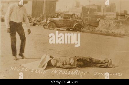 Scene from the Tulsa Race Riots of 1921. An African American man lies dead after large parts of the city were destroyed by white rioters. Stock Photo