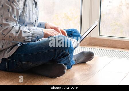 Concept of distance learning, isolation, business, shopping online. Remote working from home. Freelancer workplace in kitchen with laptop. Close up of Stock Photo