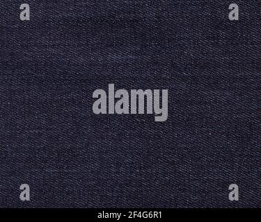 Dark blue denim with a close-up of white splashes. Background, texture, abstraction.copy space Stock Photo