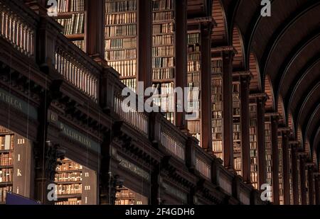 Vintage library with shelves of old books in the Long Room in the Trinity College. Dublin, Ireland - Feb 15, 2014 Stock Photo