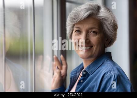 Headshot portrait of attractive senior woman enjoy life in retirement Stock Photo