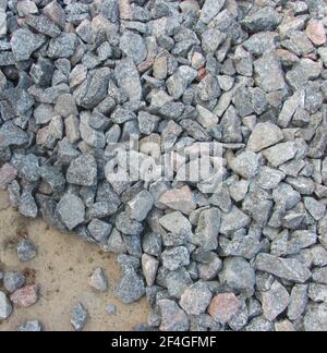 gray gravel lies on the ground Stock Photo