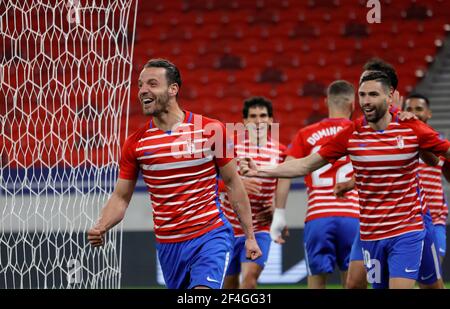 BUDAPEST, HUNGARY - MARCH 18: Roberto Soldado of Granada CF celebrates his goal with teammates during the UEFA Europa League Round of 16 Second Leg match between Molde and Granada at Puskas Arena on March 18, 2021 in Budapest, Hungary. Sporting stadiums around Europe remain under strict restrictions due to the Coronavirus Pandemic as Government social distancing laws prohibit fans inside venues resulting in games being played behind closed doors. Stock Photo