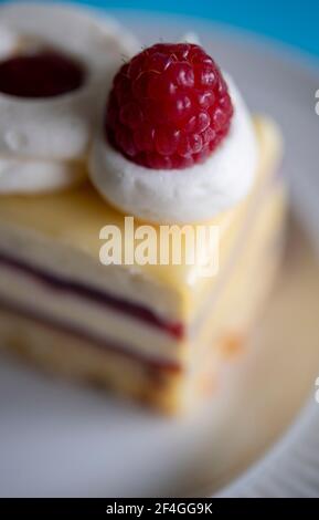 Close-up of a freshly made slice of cake with cream and jam Stock Photo