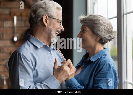 Elderly man woman in love having date at home dancing Stock Photo