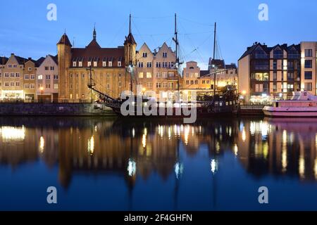 Gdansk, Poland - April 15, 2018: Gdansk at night with reflection in Motlawa river. Stock Photo