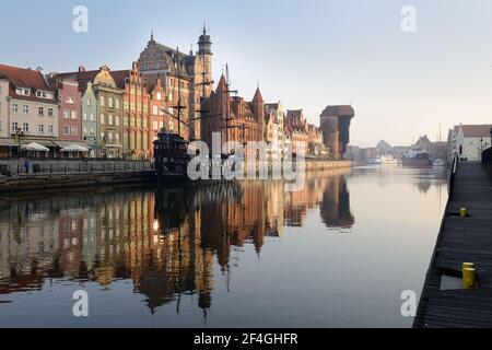 Gdansk, Poland - April 15, 2018: Gdansk Long Bridge embankment with medieval wooden ship and Zuraw Crane, Baltic coast, Poland. Stock Photo