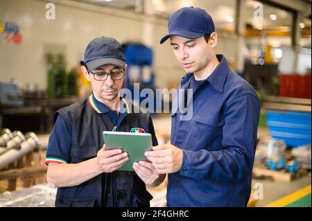 Portrait af two engineer using a tablet in a facility Stock Photo