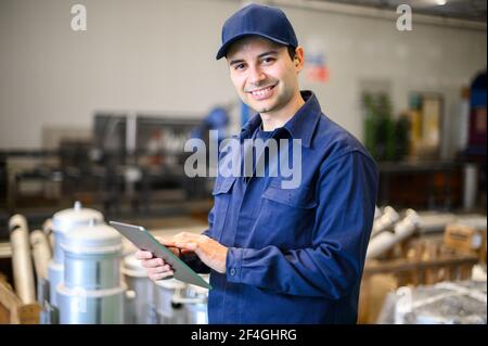 Portrait af an engineer using a tablet in a facility Stock Photo