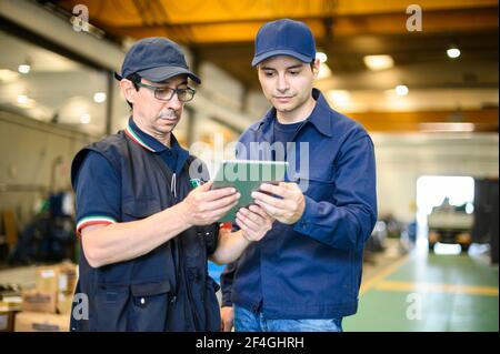 Portrait af two engineer using a tablet in a facility Stock Photo