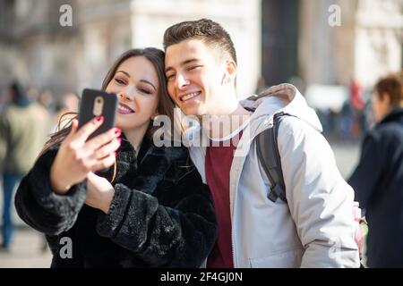 Couple of turists taking a selfie in an European city Stock Photo