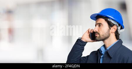 Portrait of an handsome engineer using a mobile phone Stock Photo