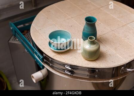 Collection of finished ceramics products made from clay by hand displayed on a kiln used in the firing process Stock Photo