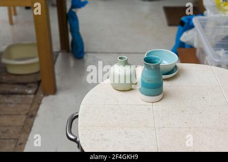 Collection of finished ceramics products made from clay by hand displayed on a kiln used in the firing process Stock Photo