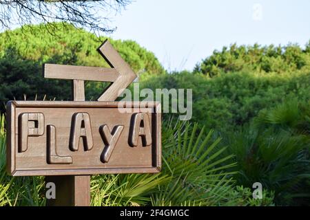 Wooden sign indicating the way to the beach Stock Photo