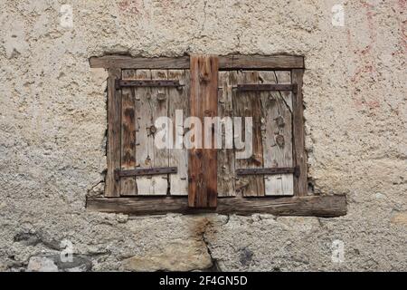 wooden shutters on the stone wall Stock Photo