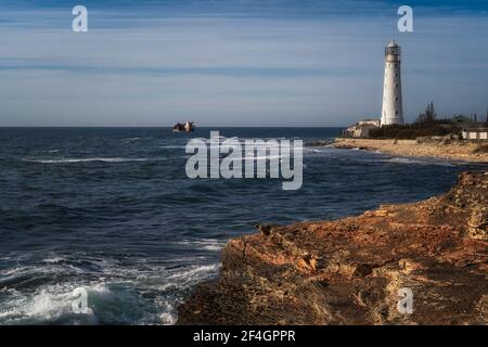 Lone beacon guards the ships. The lighthouse shows the way for boats ...